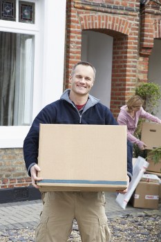 Removal team preparing flat moving boxes in a Mayfair apartment