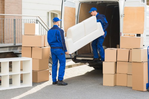 Furniture pick-up team handling bulky items in a Mayfair street setting