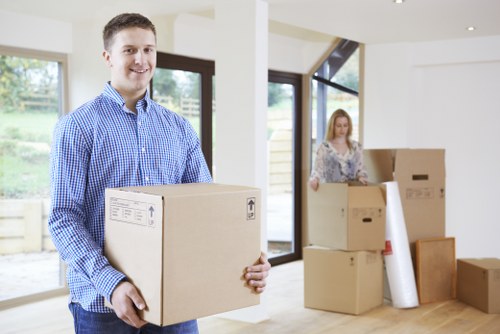 Movers carrying boxes through a central London property