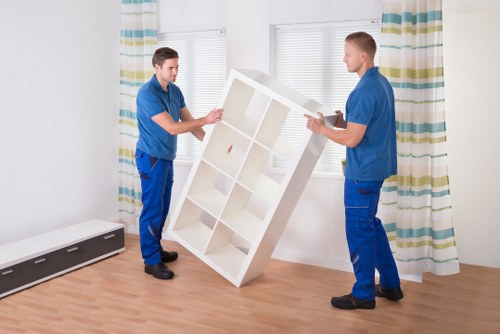 Moving team handling furniture in a central London apartment